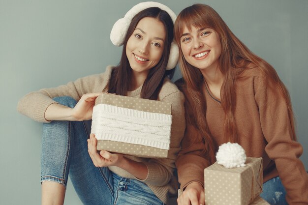 Free photo beautiful girls have fun in a studio with presents