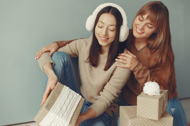 Beautiful girls have fun in a studio with presents