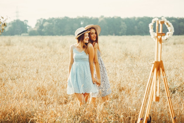 Free Photo beautiful girls have a rest in a field