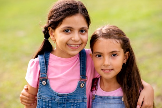 Beautiful girls hugging each other while smiling