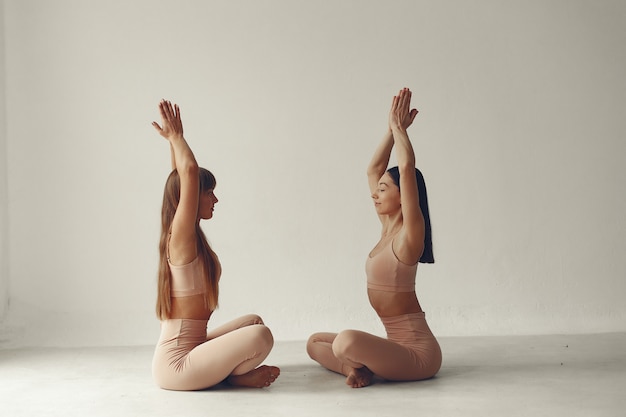 A beautiful girls is engaged in a yoga studio