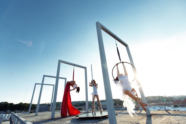 Beautiful girls  performing pole, aerial and hoop dance on roof