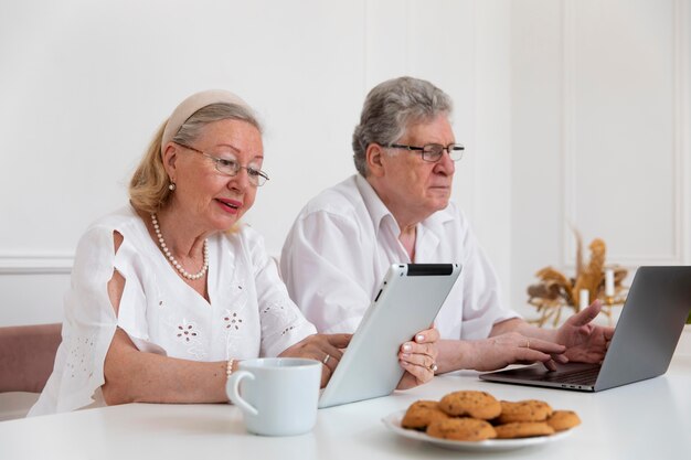 Beautiful grandparents couple learning to use digital device