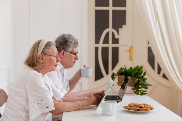 Beautiful grandparents couple learning to use digital device