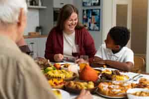 Free photo beautiful happy family having a thanksgiving dinner together