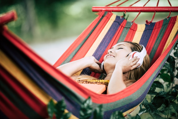 Beautiful happy young woman with headphones listening to music