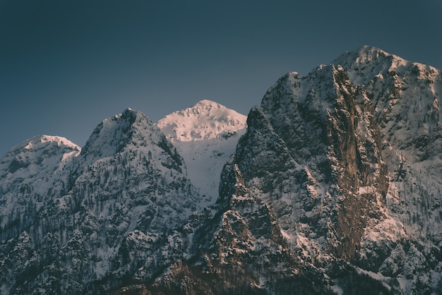 Beautiful high rocky mountains with a snowy mountain in between