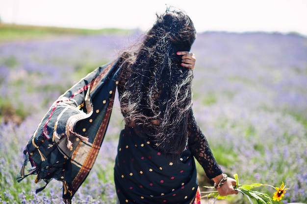 Beautiful indian girl wear saree india traditional dress in purple lavender field