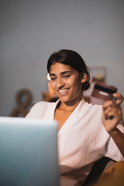 Beautiful indian woman holding a credit card