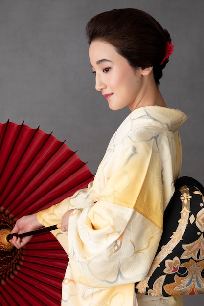 Free photo beautiful japanese model with a red umbrella