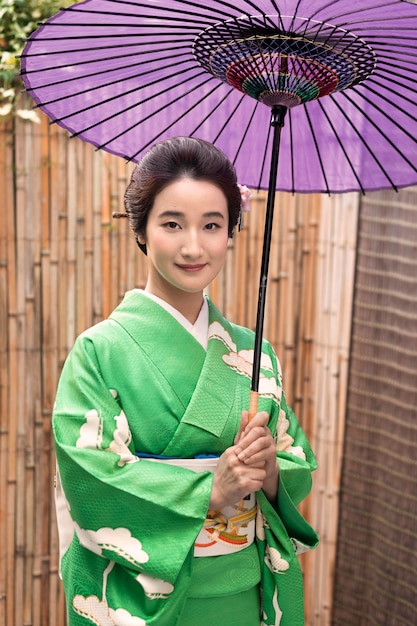 Free photo beautiful japanese woman with a purple umbrella