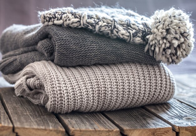 beautiful knitted clothes, neatly folded, close-up, handmade sweaters.