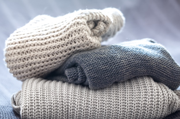 beautiful knitted clothes, neatly folded, close-up, handmade sweaters.