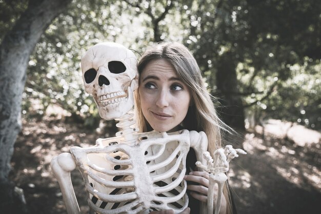 Beautiful lady behind skeleton