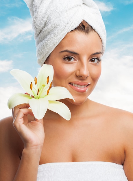 Beautiful lady in towel with lily flower