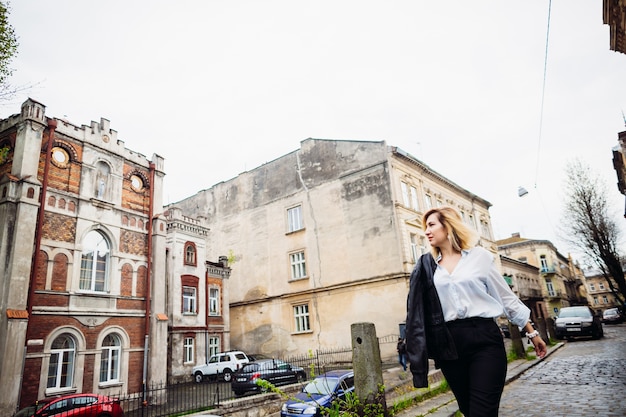 The beautiful lady walking along street