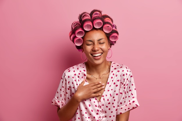 Beautiful lady wearing hair curlers isolated