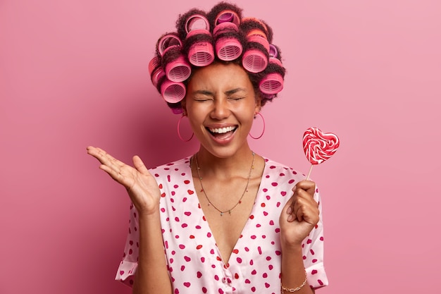 Beautiful lady wearing hair curlers isolated