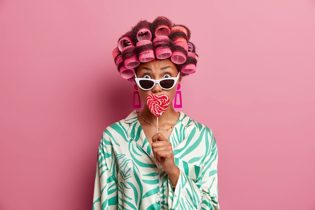 Beautiful lady wearing hair curlers isolated