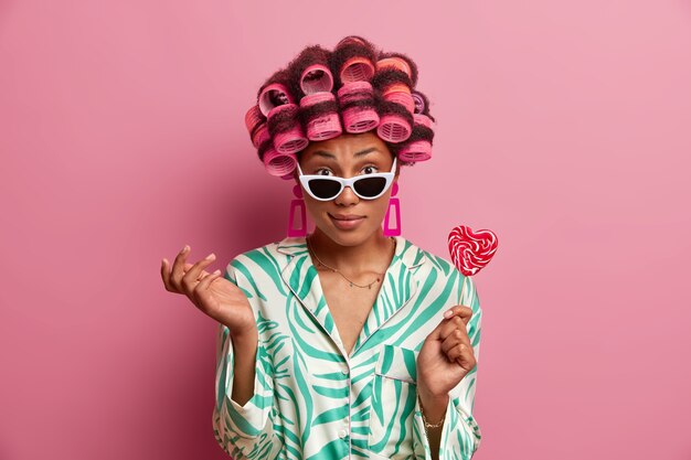 Beautiful lady wearing hair curlers isolated