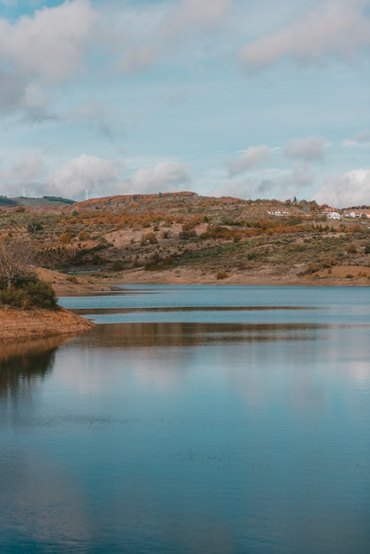 Beautiful lake surrounded by a mountain range under the breathtaking cloudy sky