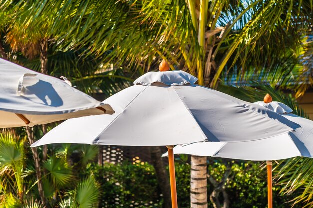 Beautiful landscape of sea ocean on sky with umbrella and chair around luxury outdoor swimming pool