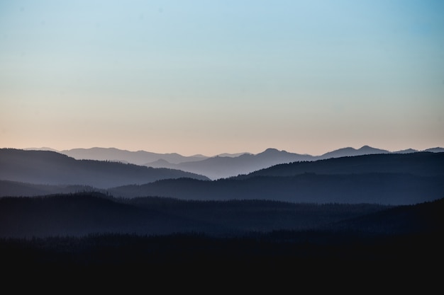 Free photo beautiful landscape shot of mountains and hills under a pinkish sky