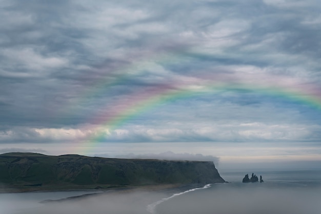 Beautiful landscape with rainbow and clouds