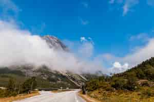 Free photo beautiful landscape with winding road in the mountains with clouds