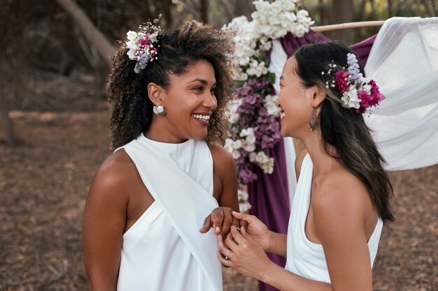 Beautiful lesbian couple celebrating their wedding day outdoors