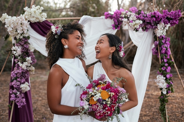 Beautiful lesbian couple celebrating their wedding day outdoors