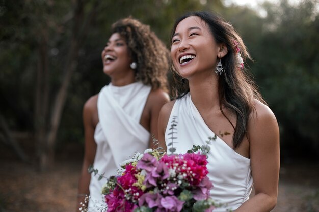 Beautiful lesbian couple celebrating their wedding day outdoors