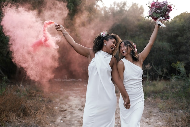 Free photo beautiful lesbian couple celebrating their wedding day outdoors