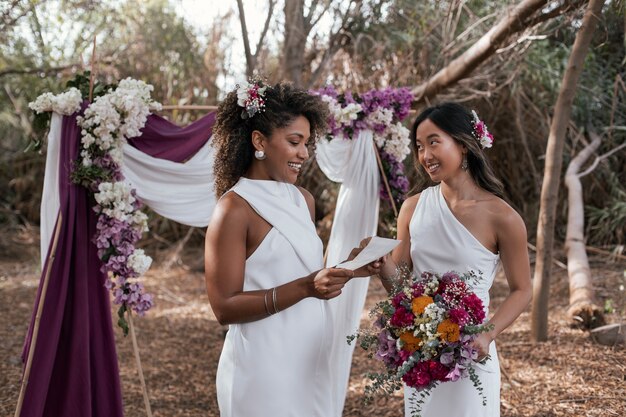 Beautiful lesbian couple celebrating their wedding day outdoors