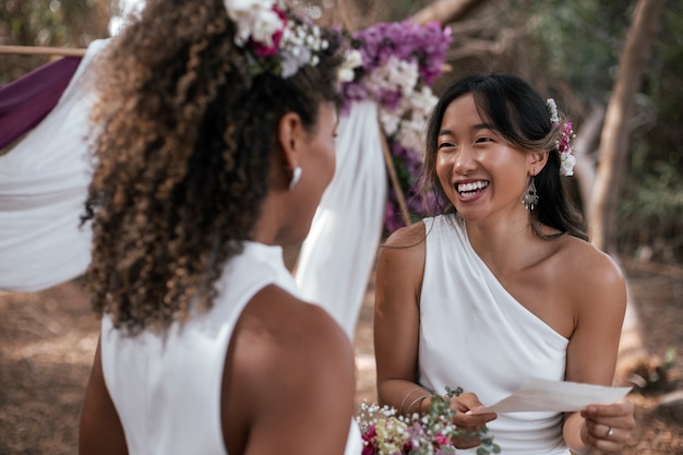 Beautiful lesbian couple celebrating their wedding day outdoors