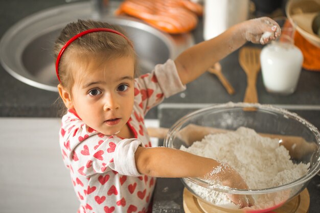 beautiful little girl Baker in the kitchen