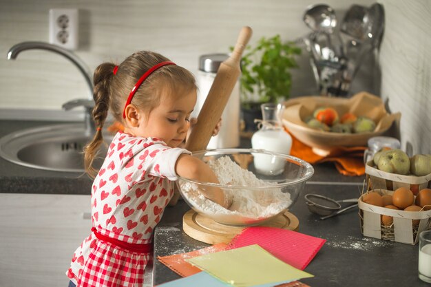 beautiful little girl Baker on kitchen