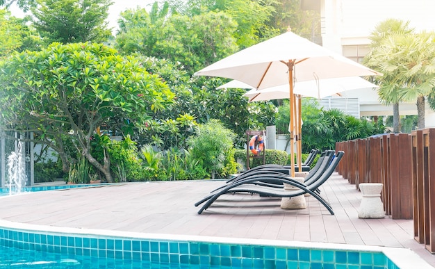 Free photo beautiful luxury hotel swimming pool resort with umbrella and chair