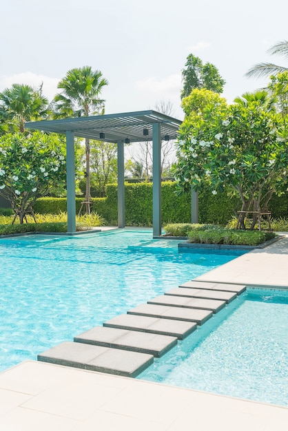 Beautiful luxury swimming pool with palm tree