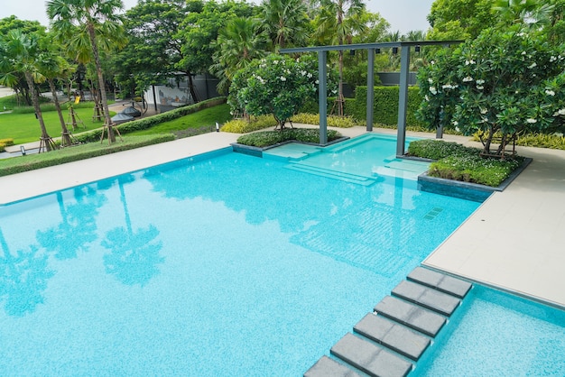 Beautiful luxury swimming pool with palm tree