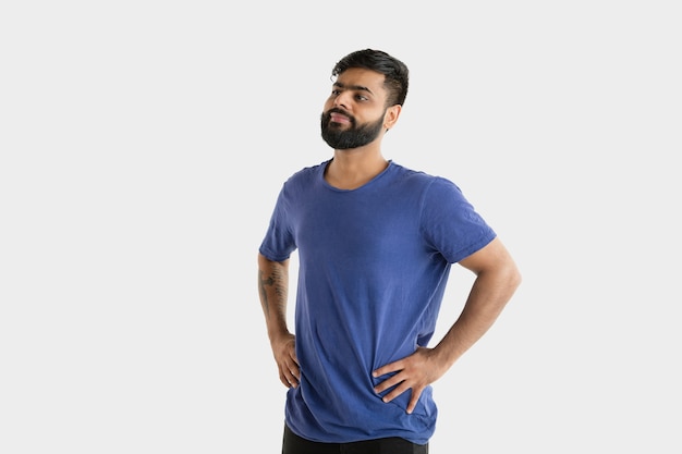 Free photo beautiful male half-length portrait isolated on white studio background. young emotional hindu man in blue shirt. facial expression, human emotions, advertising concept. standing and smiling.