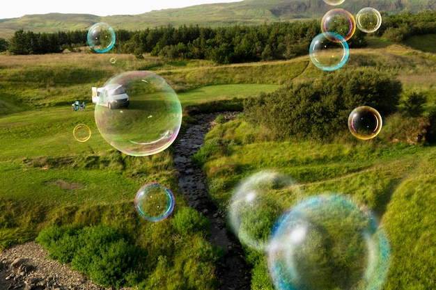 Free Photo beautiful meadow landscape and soap bubbles