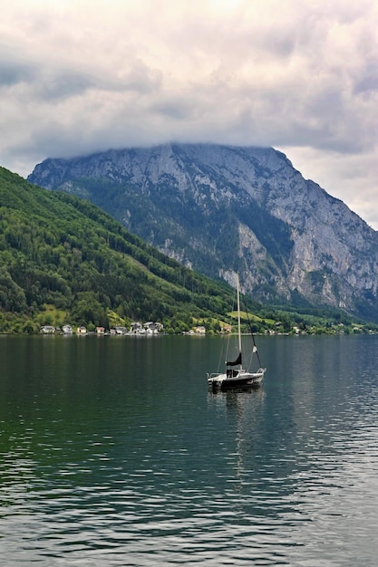 Beautiful misty and cloudy landscape with lake and mountains in summer Natural colorful background Traunsee lake in the Austrian applause  Gmunden