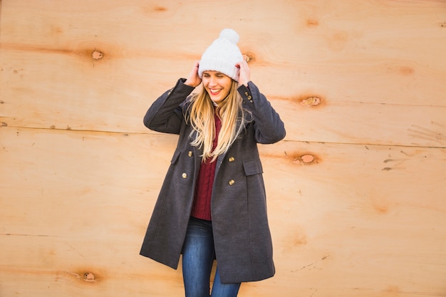 Free photo beautiful model adjusting hat and smiling