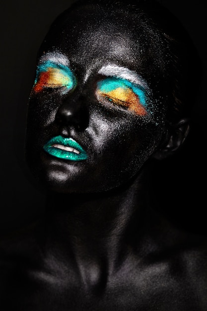 Free Photo beautiful model woman with creative plastic unusual black mask bright colorful makeup with black face