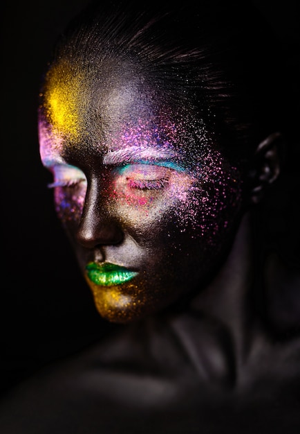 beautiful model woman with creative plastic unusual black mask bright colorful makeup with black face