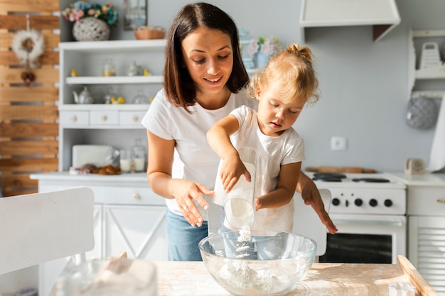 Beautiful mother and daughter cooking together