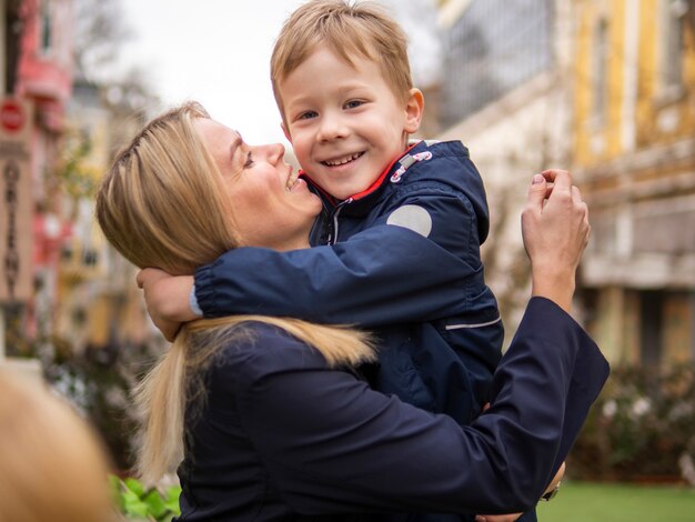 Beautiful mother holding her child outdoors