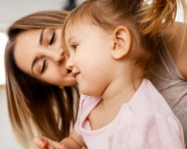 Beautiful mother spending time together with her daughter at home