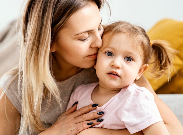 Beautiful mother taking care of her daughter